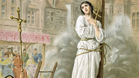 patron saint of france burned at the stake|Joan of Arc is burned at the stake for heresy .